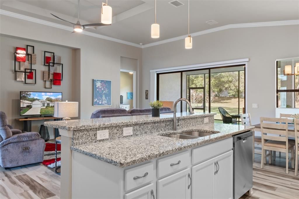 The cook can always be a part of what's going on in the great room and never has to miss out on activities. FYI, a built-in & pull-out trash/recycle bin is to the left of the sink for convenience.