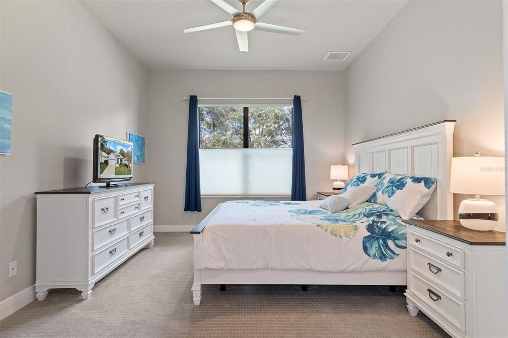 The generous primary bedroom has ample room for a king size bed and 2 night stands, as well as other furnishings. You'll love the silhouette blinds that can open from the top or bottom. The bedroom overlooks the backyard.