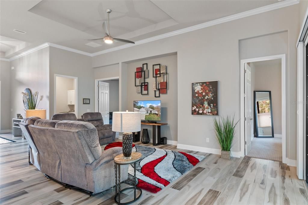 Looking from the sliding doors across the great room - the doorway on the right is into the primary suite, the center doorway is into the third bedroom/flex space, and the door on the left is to the laundry room.