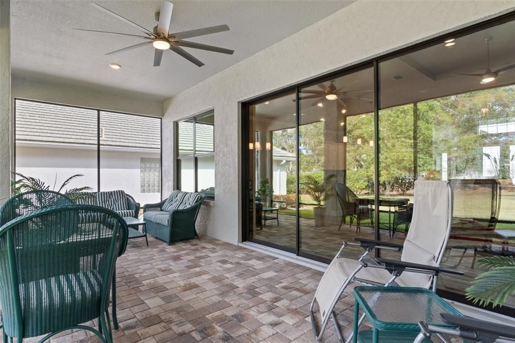 You'll appreciate the covered and screened lanai, complete with pavers, ceiling fan, and recessed lighting.