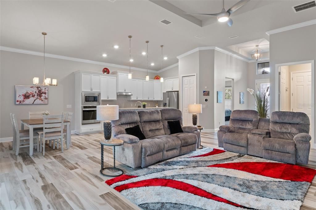 View of the living area as you exit the primary bedroom. The doorway to the right of the pantry door leads to the guest bed and bath area.