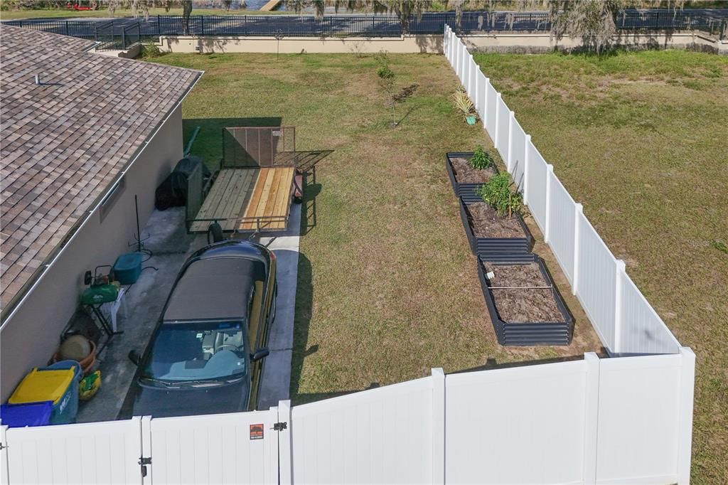 parking pad on side of house behind fence gate