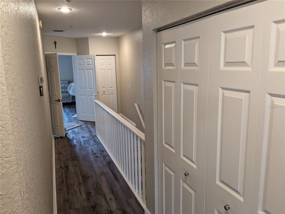 Upstairs hall from 2nd bedroom. Washer & Dryer behind doors.