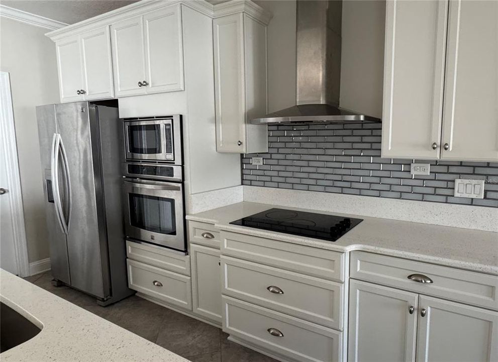 Dream Gourmet Kitchen with custom backsplash and Stainless Hood