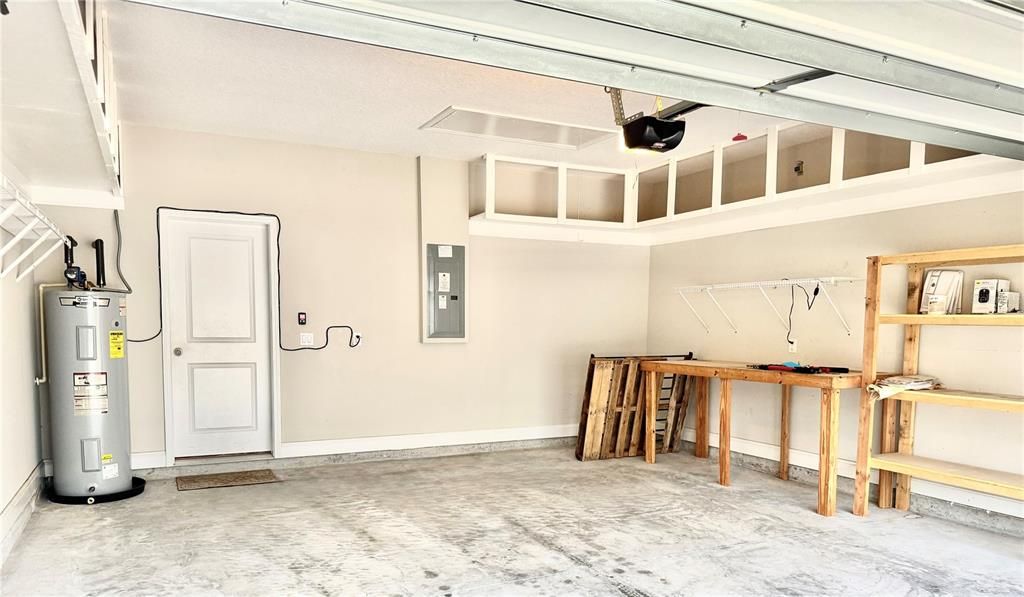 Garage with so much storage and pull down stairs to attic storage