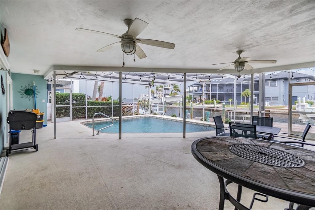 Enjoy the ultimate Florida lifestyle in this expansive screened-in patio overlooking the sparkling pool and serene waterfront.