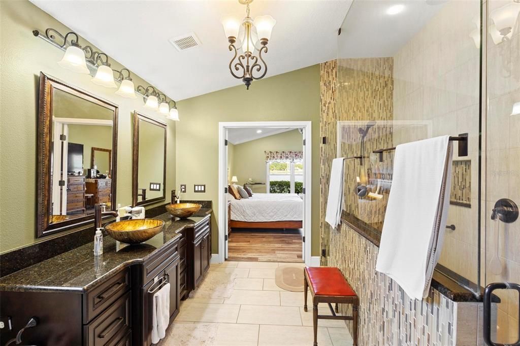 Ensuite bath towards entrance. The oversized walk-in shower features floor to ceiling tile.