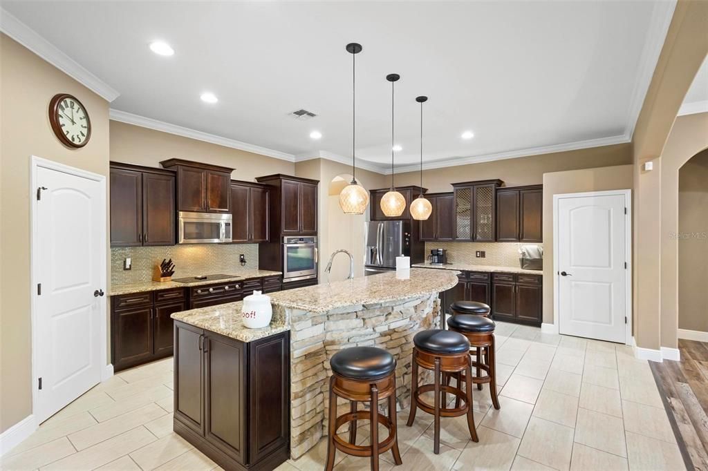 This beautiful kitchen features two storage pantries and an abundance of cabinetry.