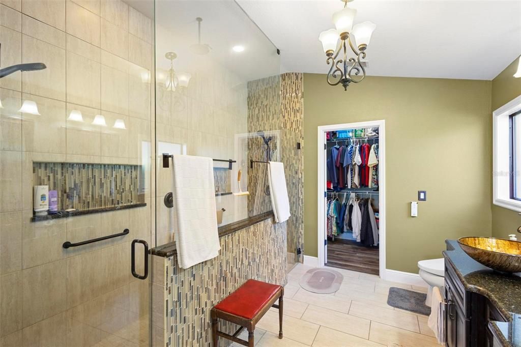 Ensuite bath with huge walk-in shower, 3 showerheads and floor to ceiling tile.