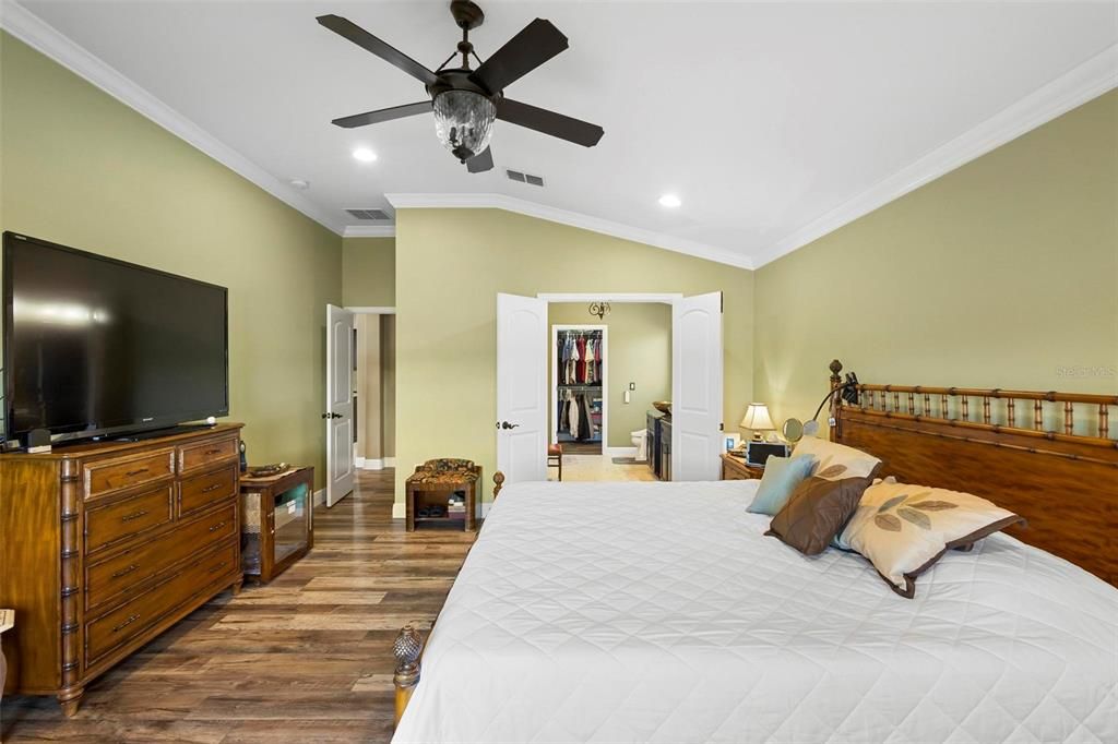 Primary bedroom. Entrance left, ensuite bath right. The tall ceilings give a spacious feeling.