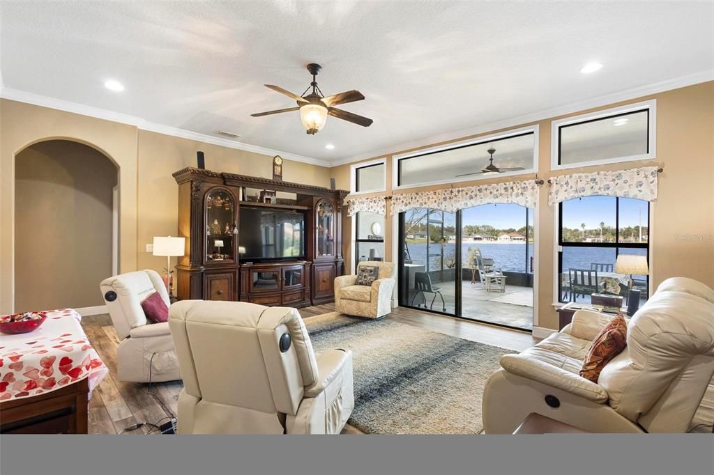 Family room with lake views towards primary bedroom suite.