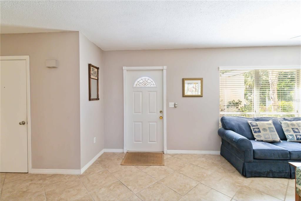 As you enter you will find the living room.  The other door is the exit to the garage for your convenience.