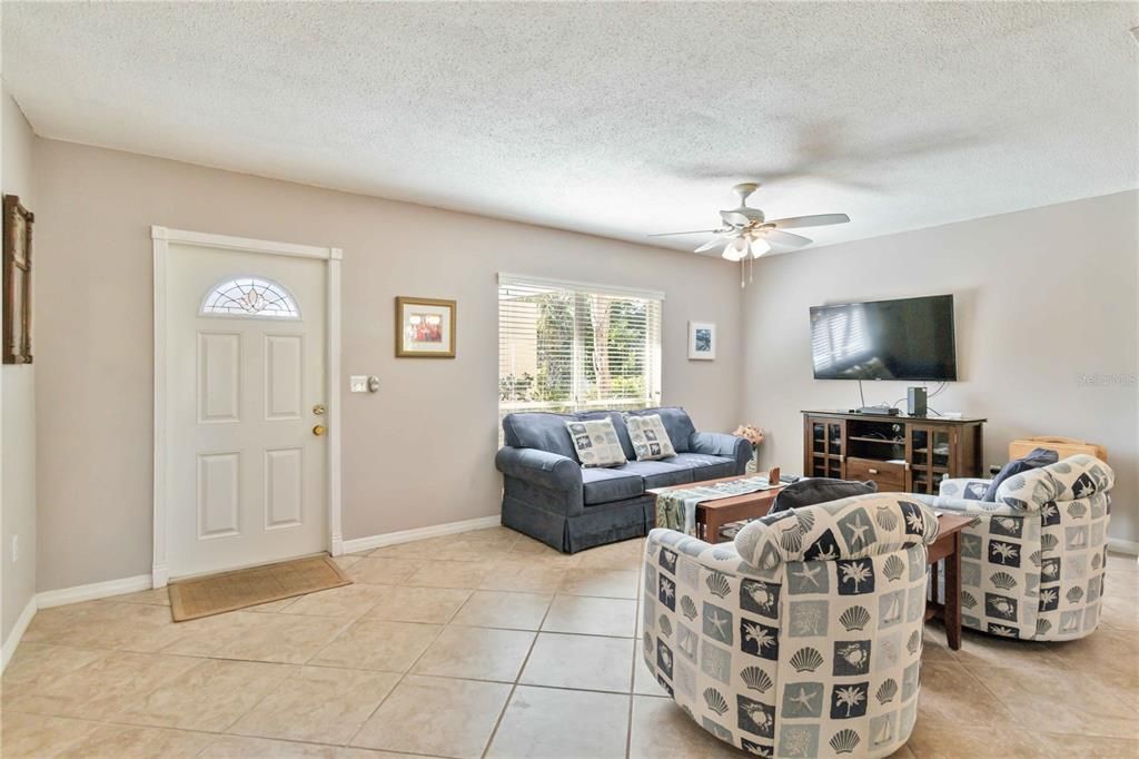 Light and bright living room with a ceiling fan.