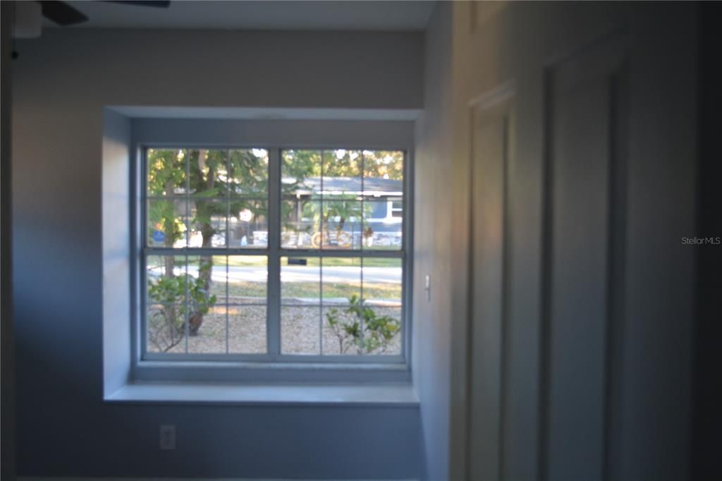 Bedroom with seating area under one of the windows