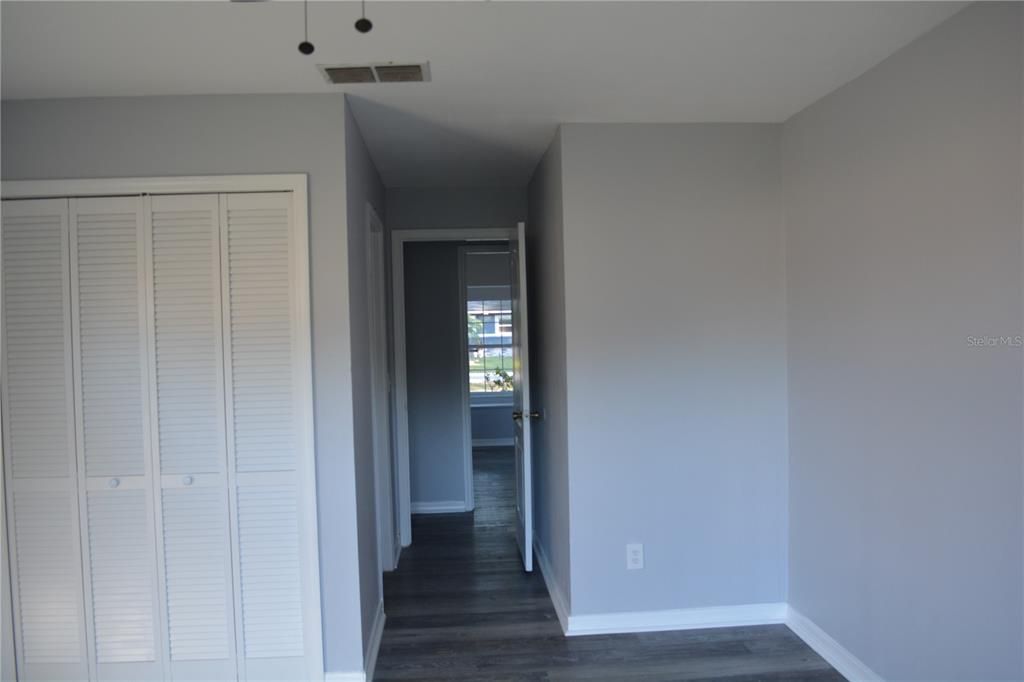 View looking out of the primary bedroom to the bedroom across the hallway