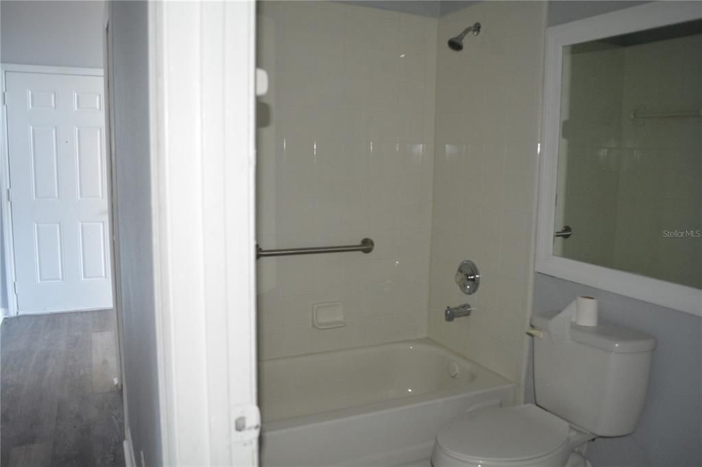 Second bath room off the hallway with tub and shower * tile floors