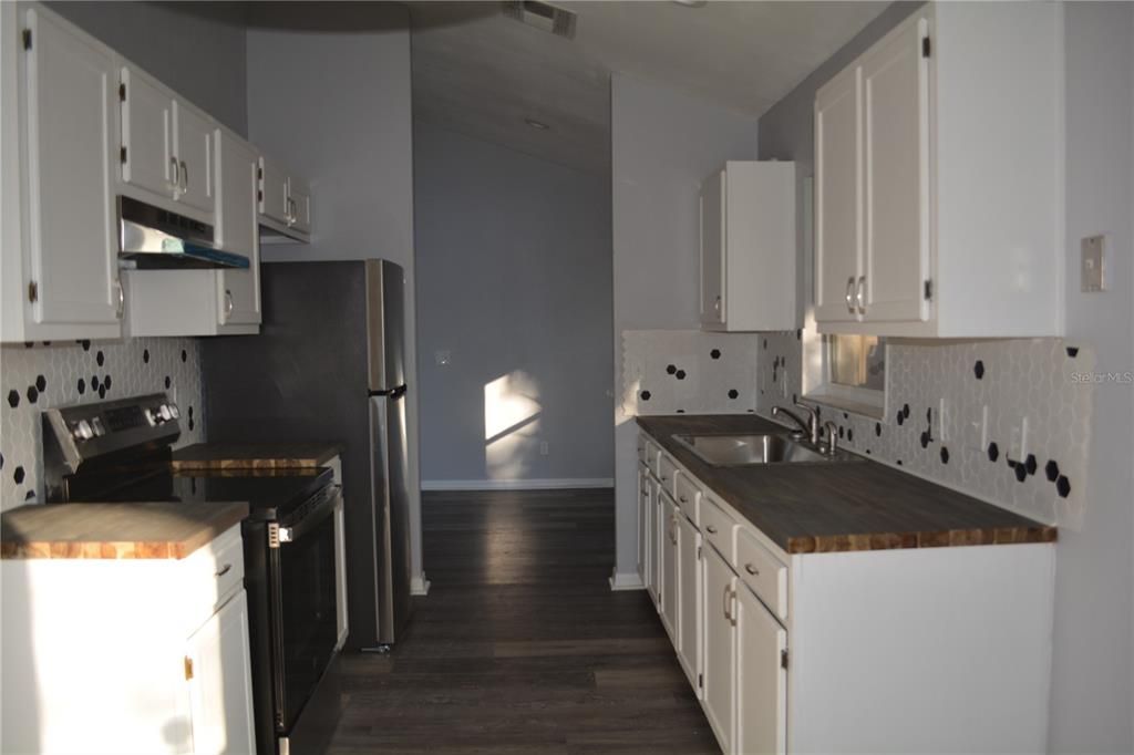 Completely remolded kitchen with title backsplash