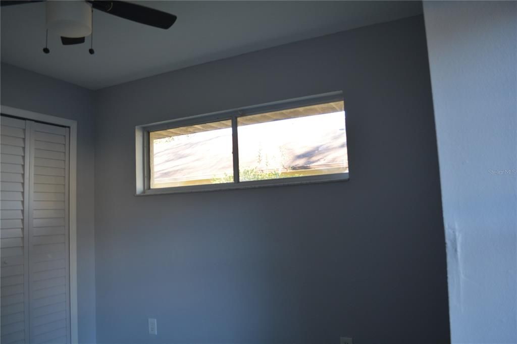 Second bedroom with transom window for extra wall space for furniture