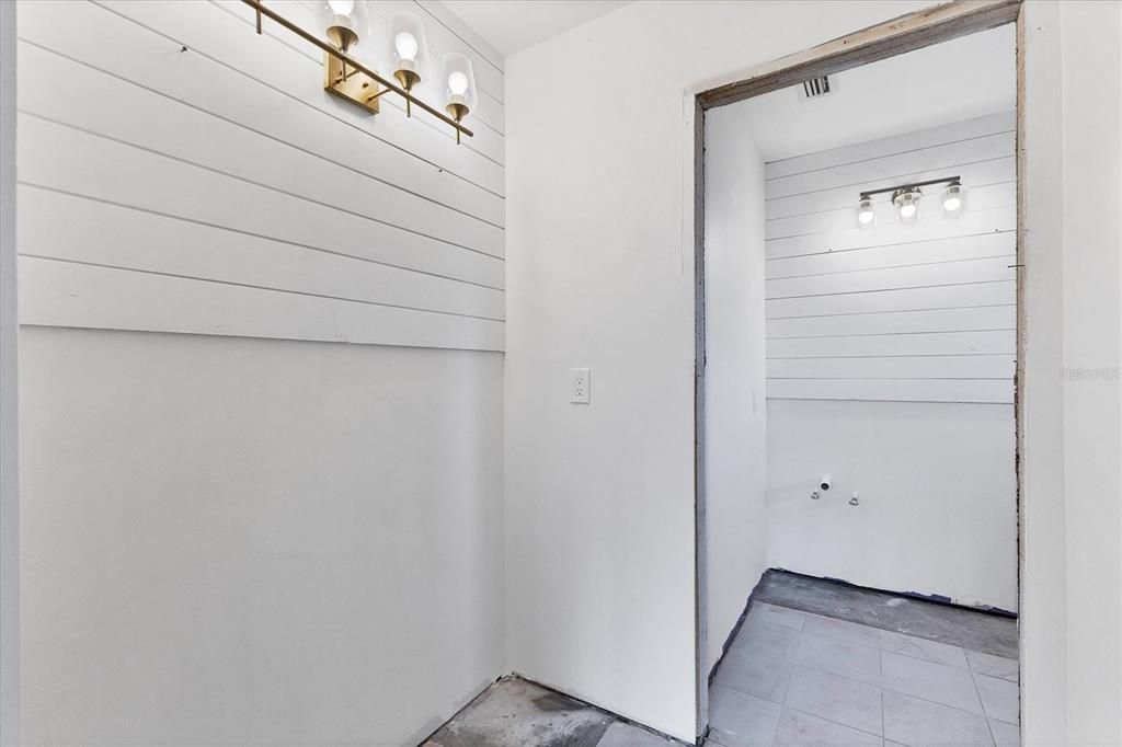 Primary bedroom dressing area with view to bathroom