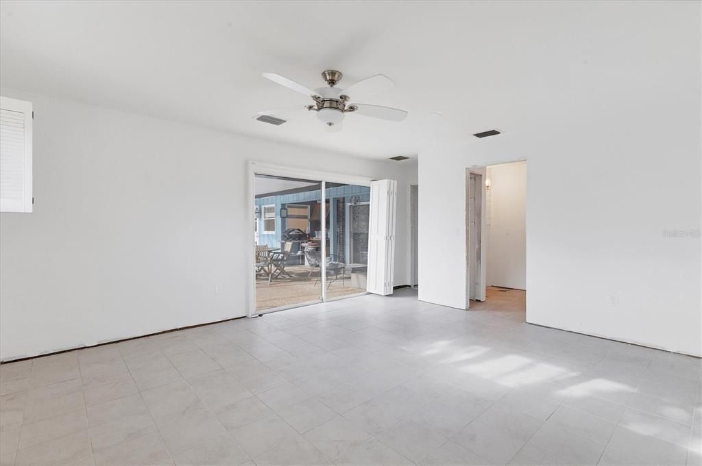 Primary bedroom with view/access to pool patio