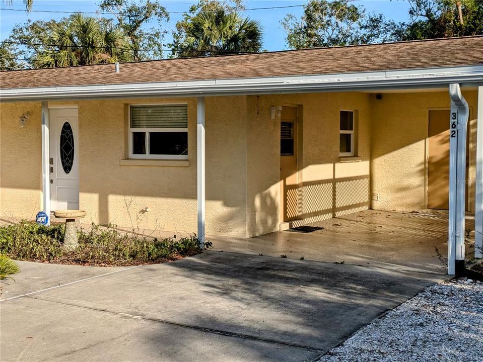 Carport with laundry room door in the background