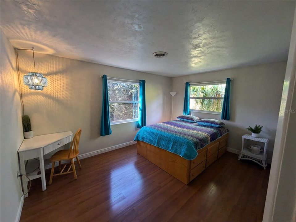 The guest bedroom has two large windows for lots of natural light.