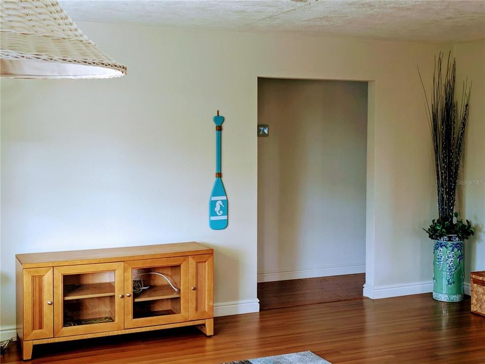 Hallway from the living room. The primary bedroom is to the right, the guest bedroom is to the left. For privacy, the bedrooms are separated by the guest bathroom, primary bathroom and closets.