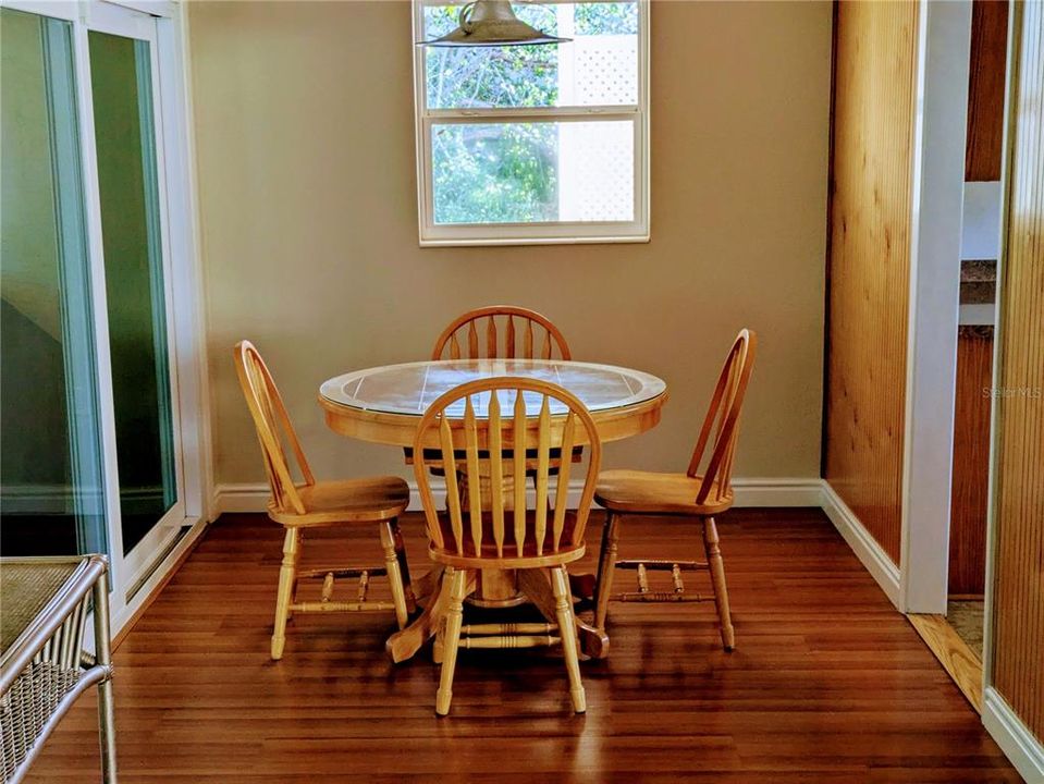 The dining room features sliders to the covered, screened lanai. The kitchen is to your right.