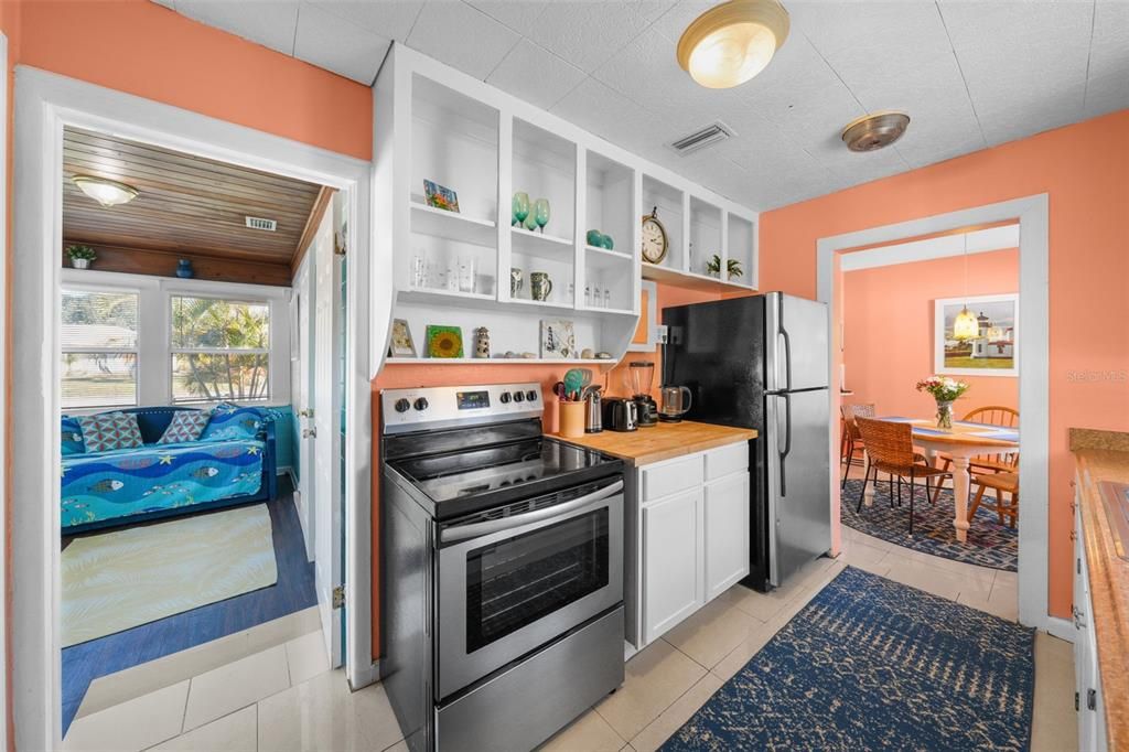 Where style meets function; Stainless fridge and range with shelving all the way to the ceiling