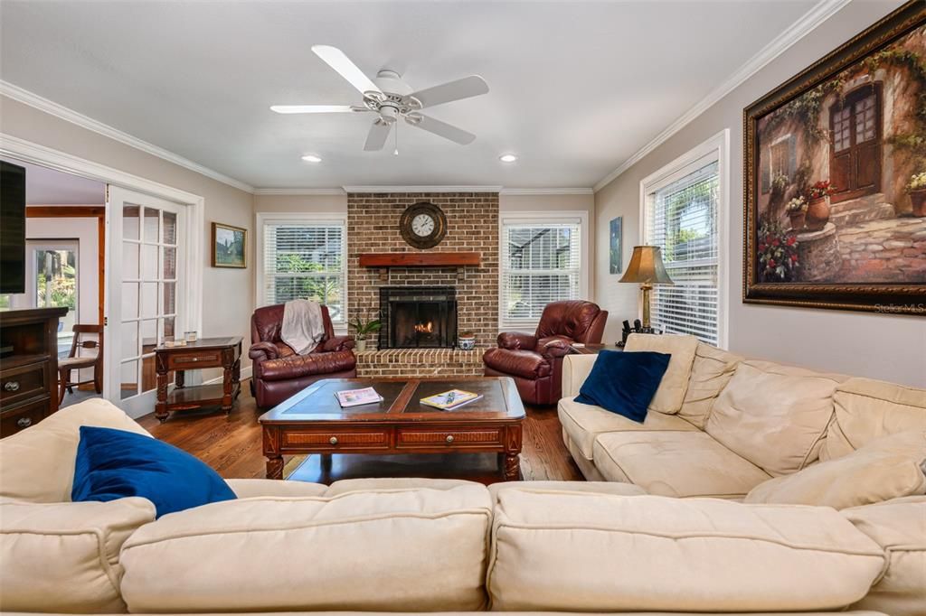 Family room with another wood burning fireplace.