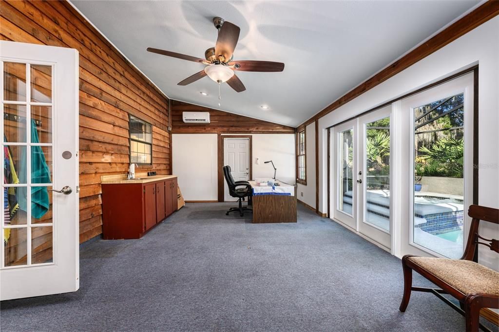 Florida room has been used as a play room for the kids, art studio or craft room. New french doors lead out to the screened pool & spa. Room has a sink. The single door leads out to a court yard.