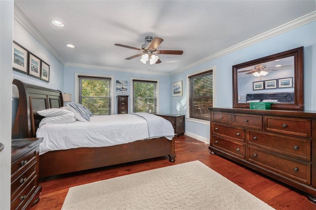 Spacious primary suite with crown molding, new windows and engineered hardwood flooring.