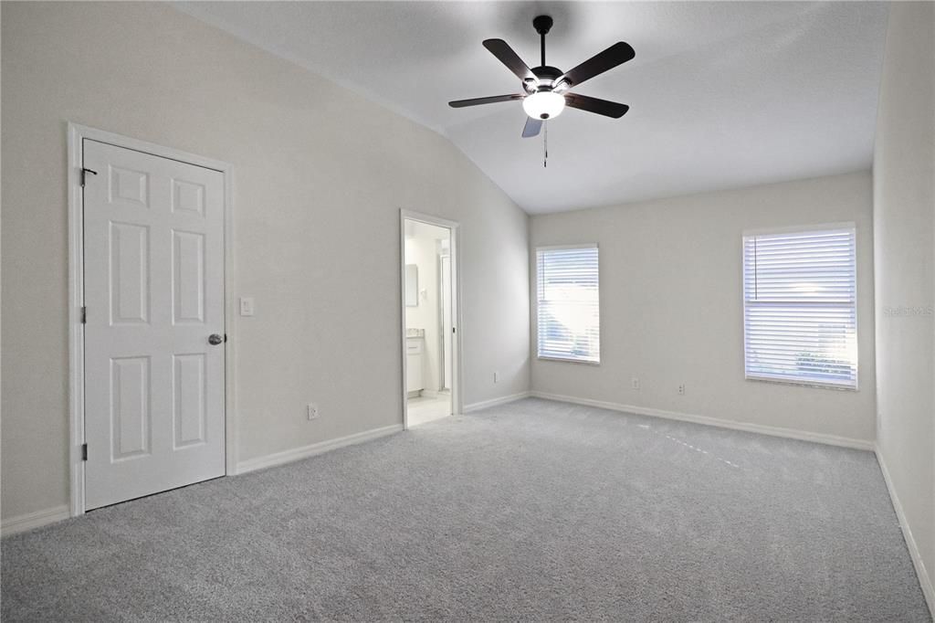 primary bedroom suite with a walk-in closet