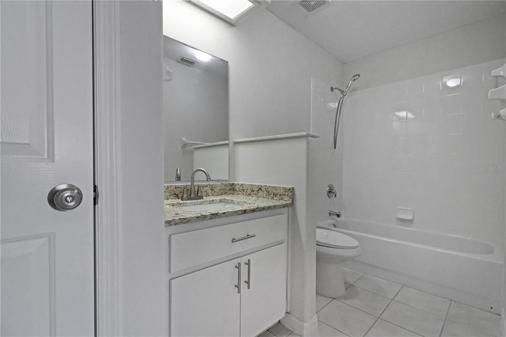 Guest bath with tub and linen closet