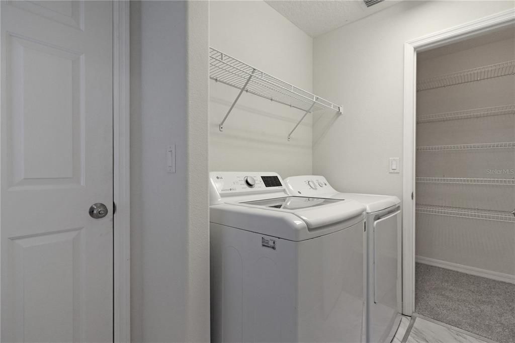 Laundry room with large storage closet