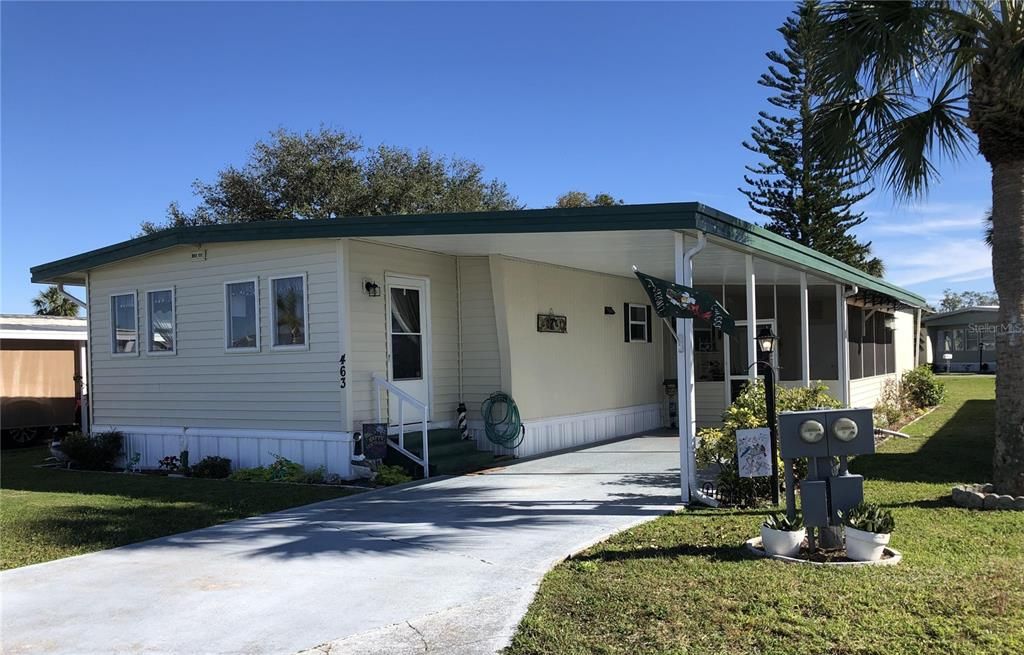 Front with carport and covered porch area