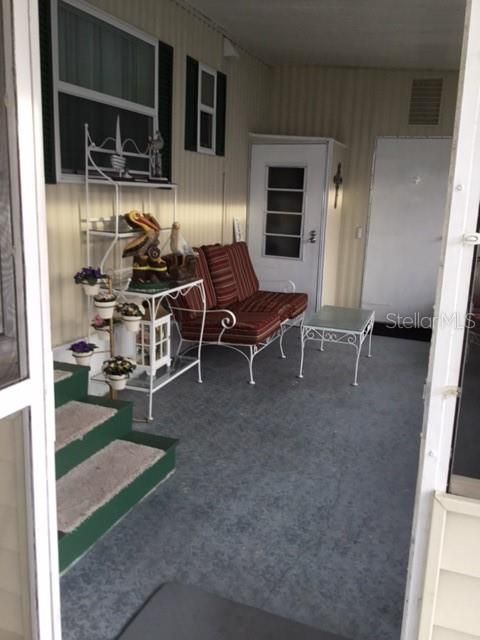 Interior of screened porch area on side of home