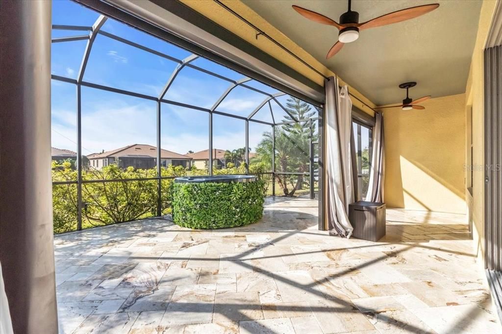 Oversized lanai with Travertine Paver Tiles, Motorized Kevlar Hurricane Screens and Dual Fans on the Lake | 368 Cedar Falls Dr, Apollo Beach, FL  33572