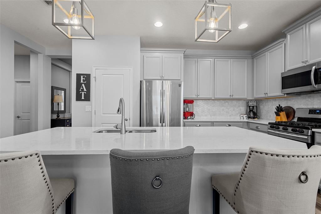 Kitchen - Quartz Countertops, designer backsplash, stainless steel appliances, and gas range