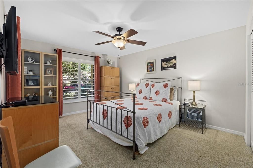 This second bedroom, located at the front of the home, is perfect for guests and features plantation shutters for added privacy.