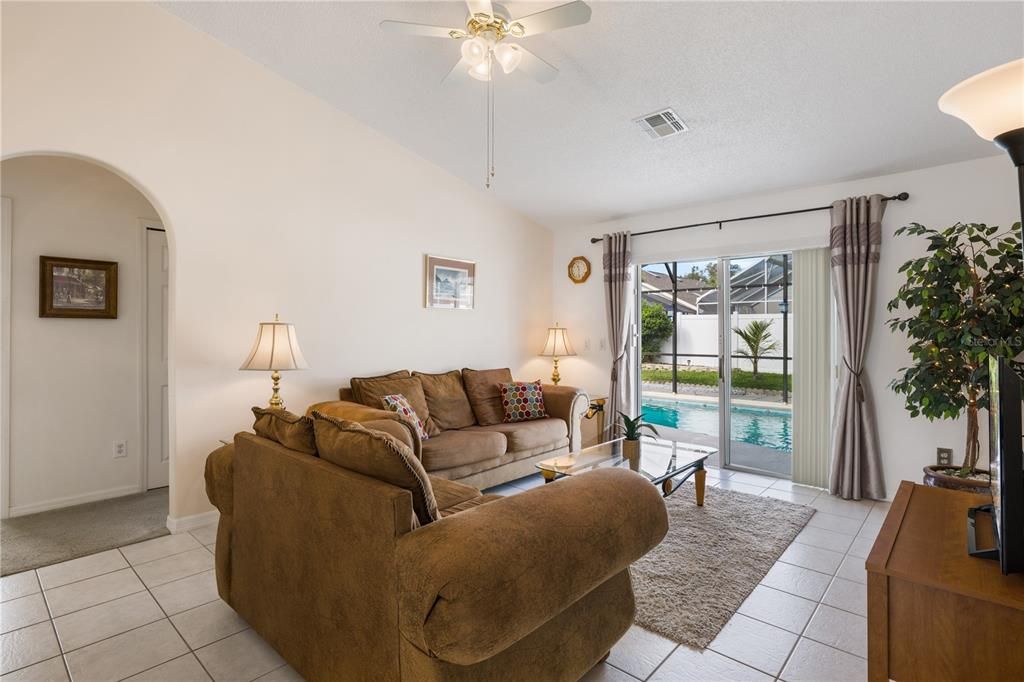 Living room with sliding glass doors to patio and pool