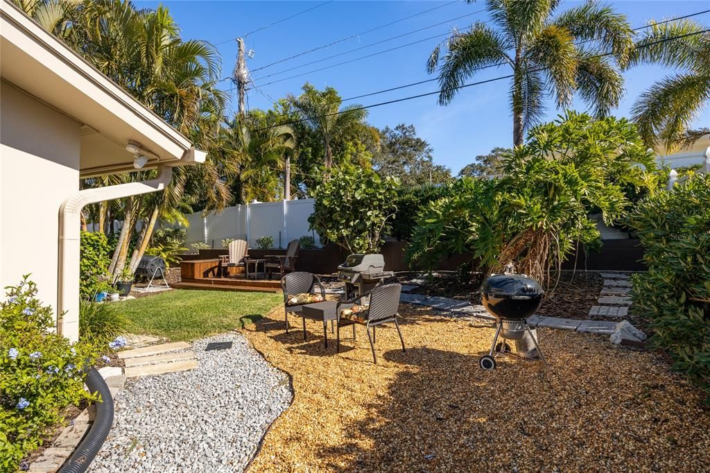 The back yard has several entertaining and/or relaxation areas, including this meticulously landscaped grilling area that gets full sun!