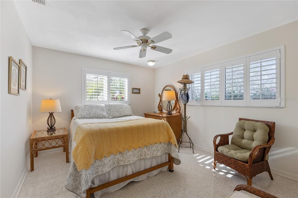 Both guest bedrooms have beautiful polished terrazzo flooring and large windows with plantation shutters.