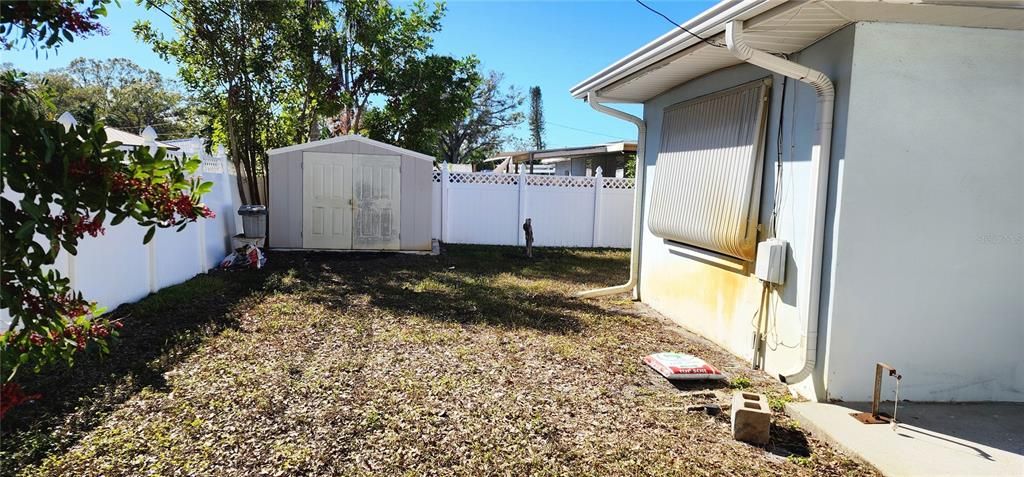 One side of fenced yard with shed