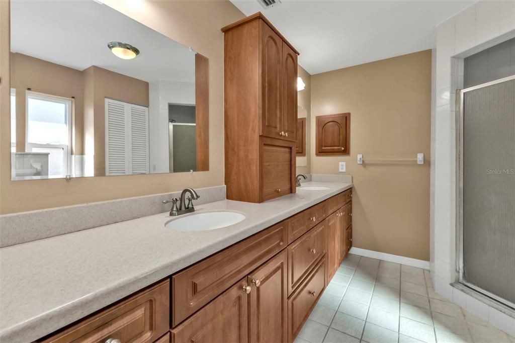 Duel sinks, wood cabinets and Corian counter