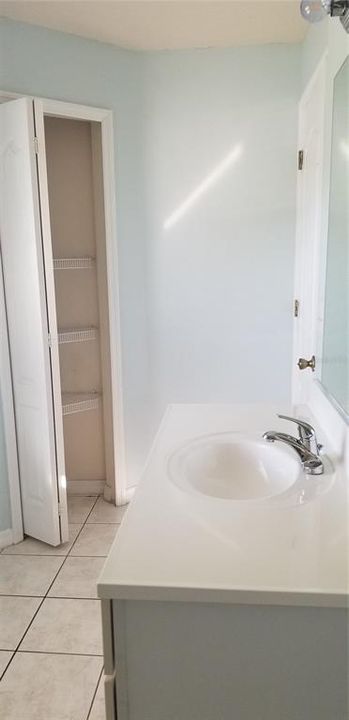 first floor bathroom with new vanity counter top, fixtures and new shower tile surround january 2025