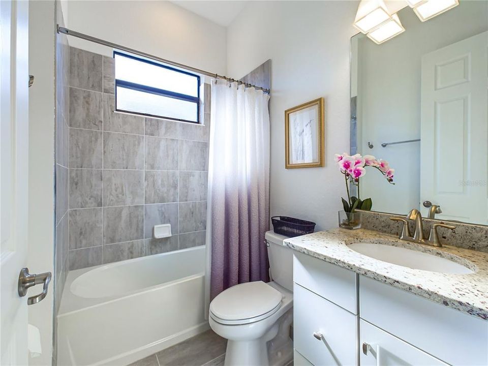 Guest Bathroom Positioned Between Two Bedrooms.