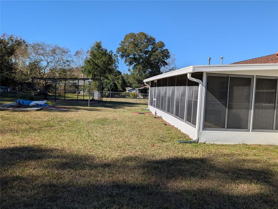 CARPORT, LARGE LANAI WITH VINYL WINDOWS, FLOORING FOR SMALL SHED.