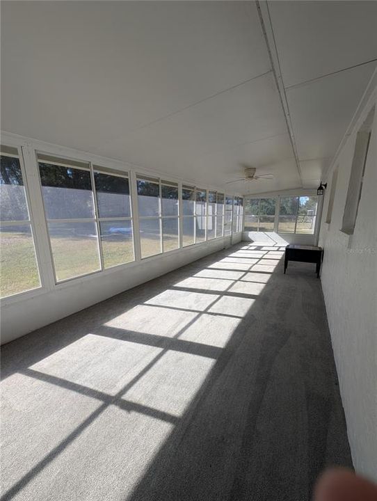 HUGE CARPETED LANAI WITH VINYL WINDOWS