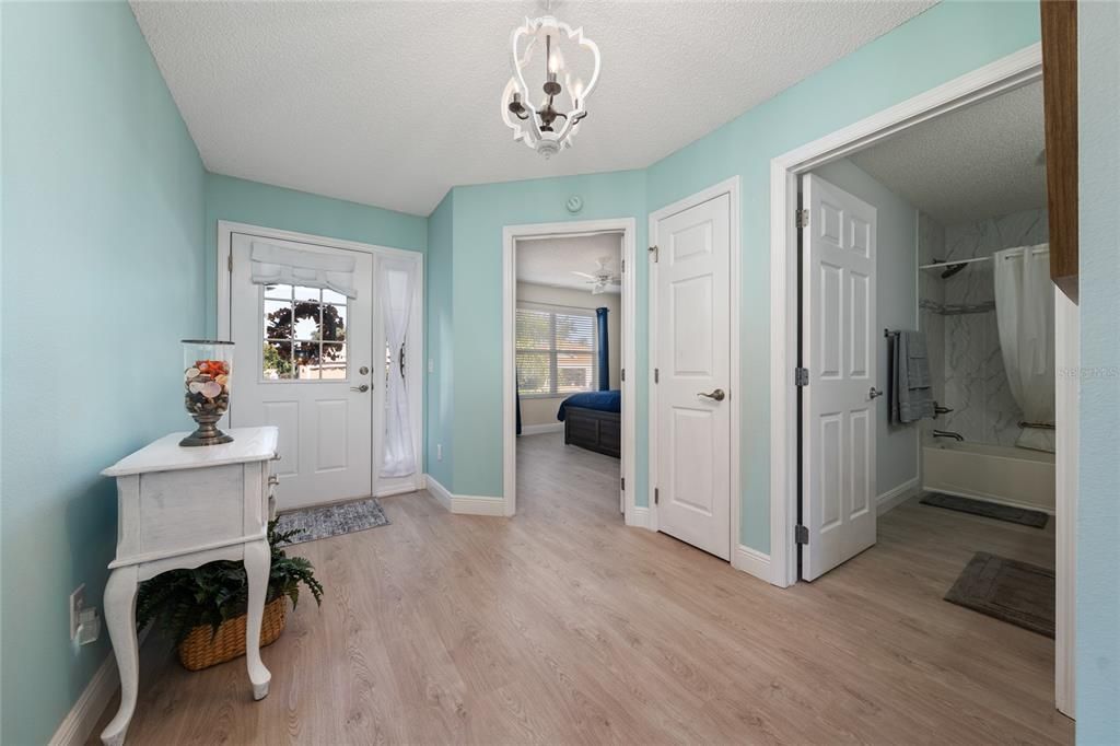 Foyer entrance with closet, access to second bedroom, second bathroom, and laundry room.